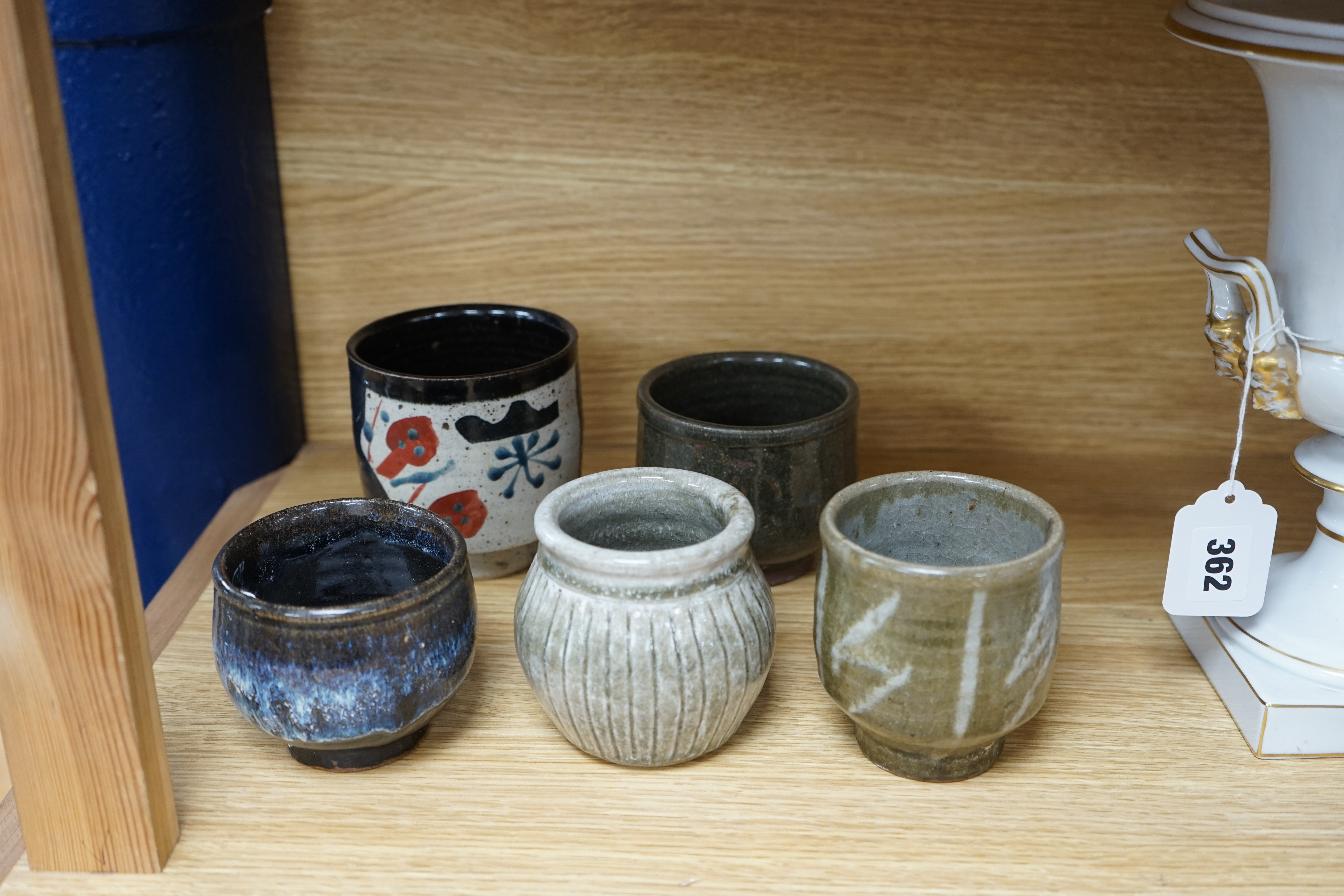 Five Japanese and European studio pottery yunomi, including an example by John Maltby, 10.5cm, together with another signed with a ‘P’ to the base. Condition - good.